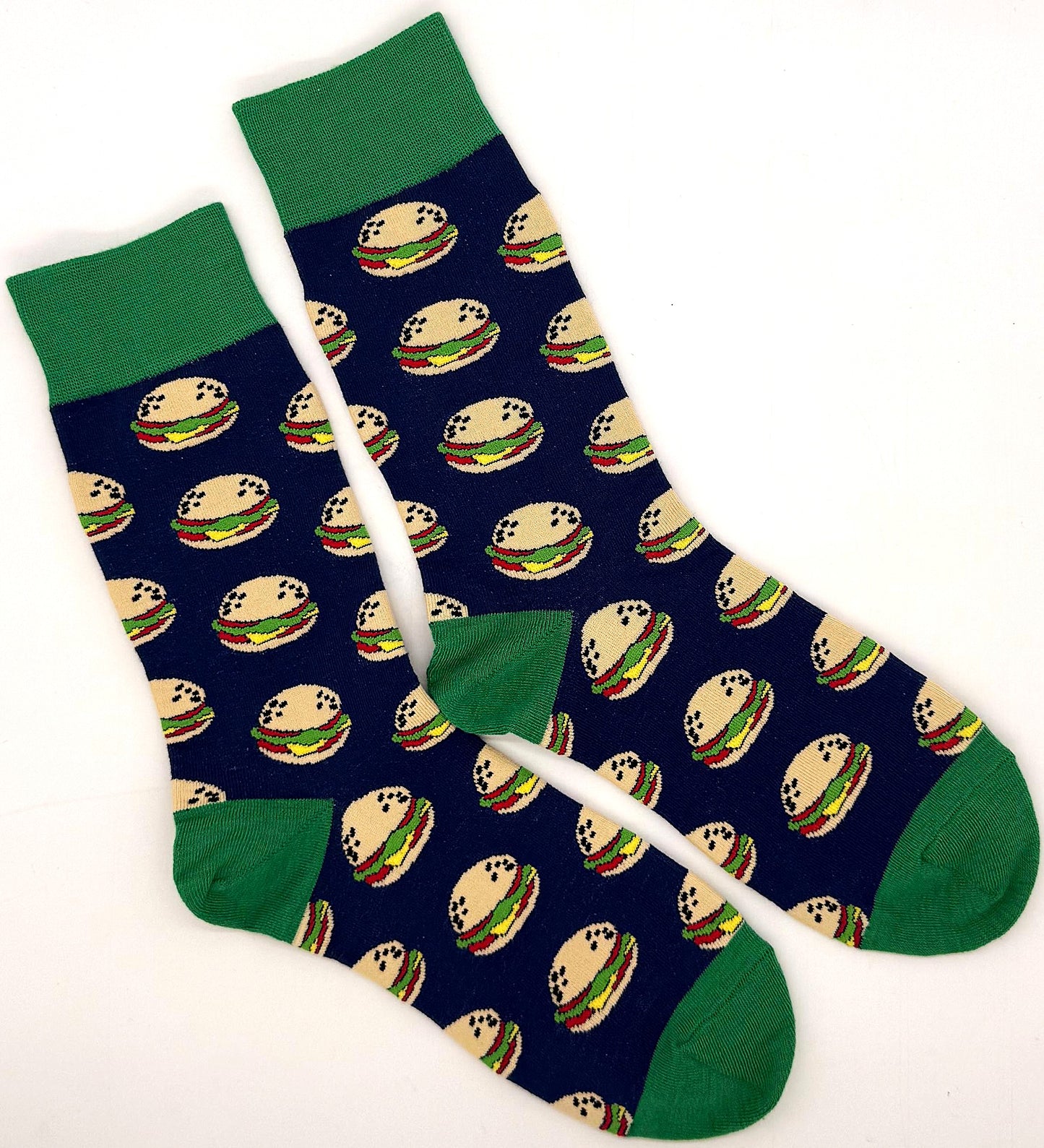 Navy blue socks with hamburger pattern and green accents on a white background