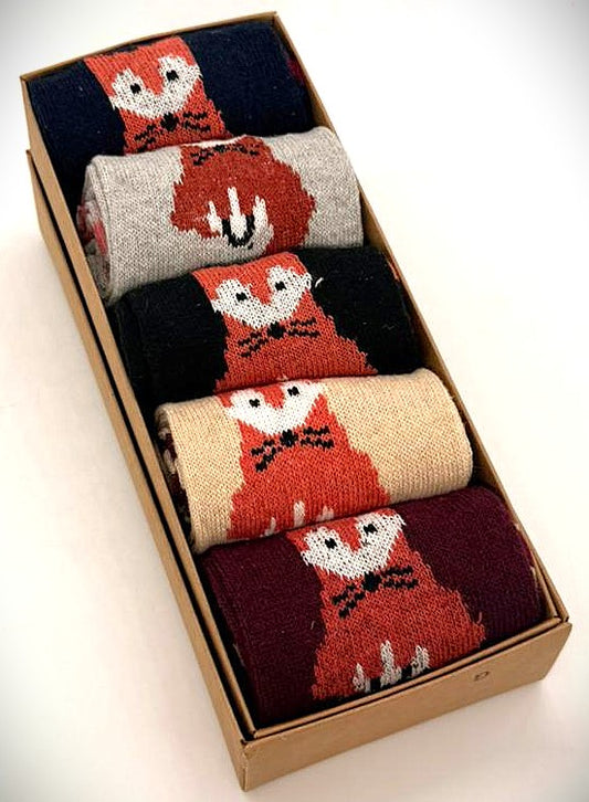 Set of fox-themed socks in a cardboard box on a white background