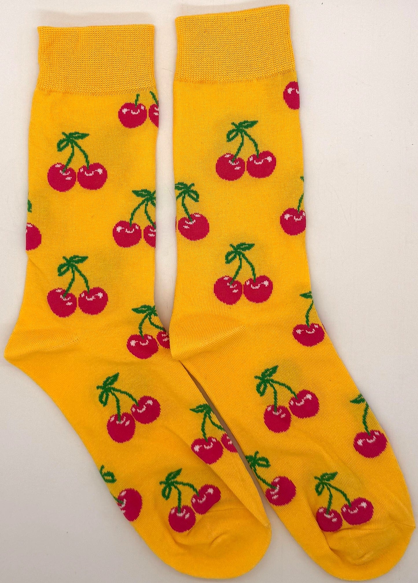 Yellow socks with cherry pattern on a white background